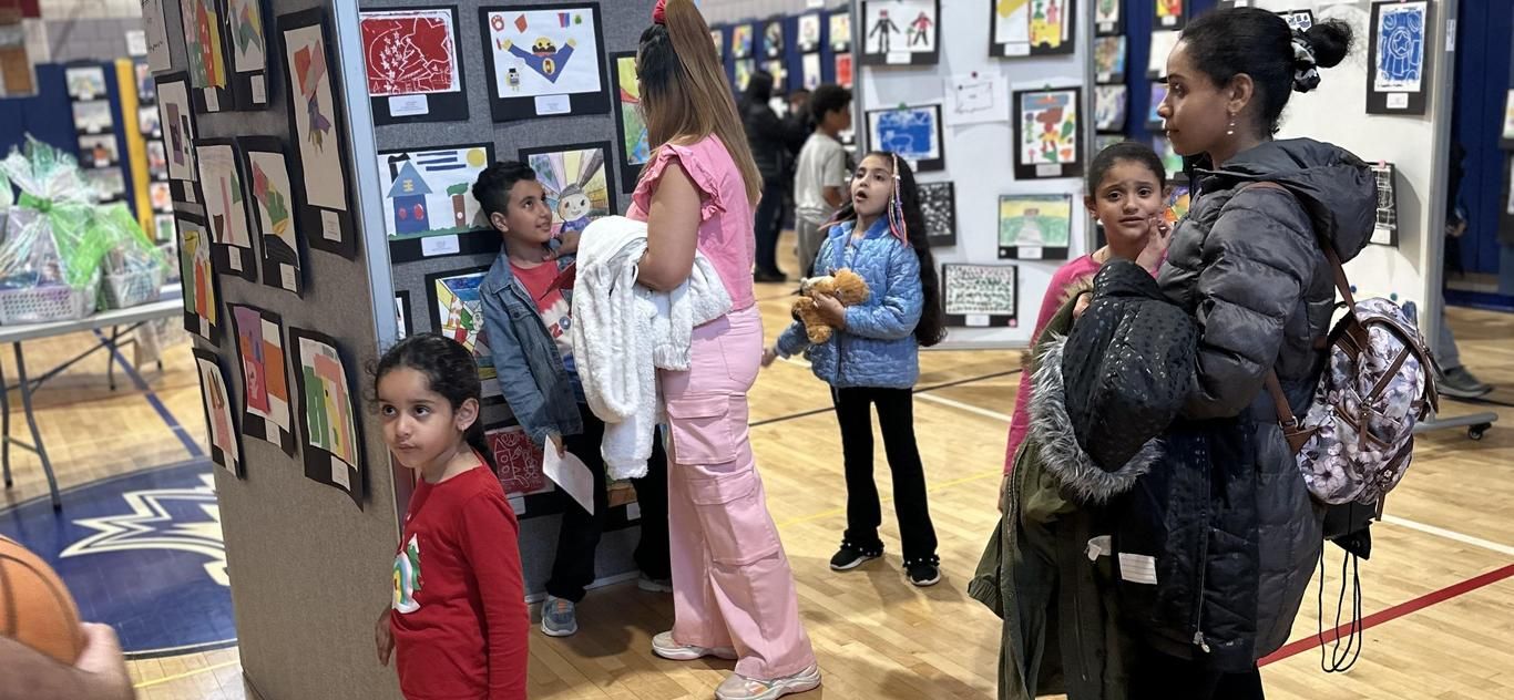 Families browsing student artwork at the PS 88Q Art Show